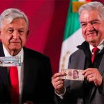 López Obrador, left, and lotteries chief Ernesto Prieto with raffle tickets.
