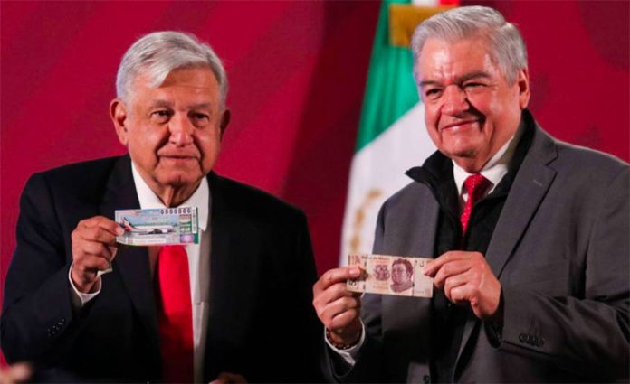 López Obrador, left, and lotteries chief Ernesto Prieto with raffle tickets.
