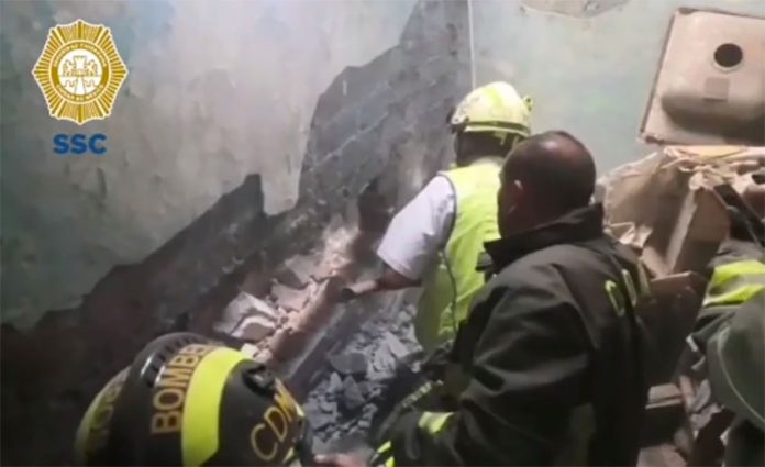 Rescue workers break through a wall to retrieve abandoned baby.