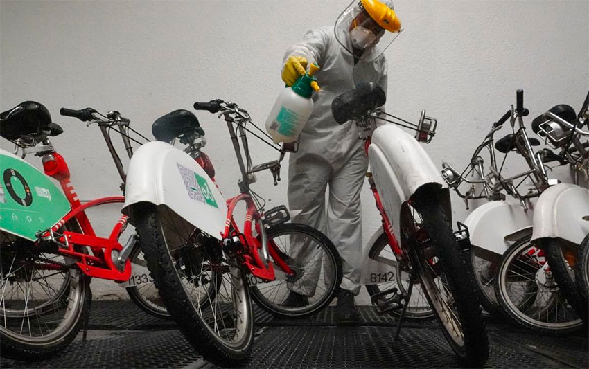 A worker disinfects bicycles belonging to Mexico City's bike sharing program Ecobici.