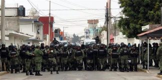 Security forces at the scene of the rail blockade Tuesday morning.