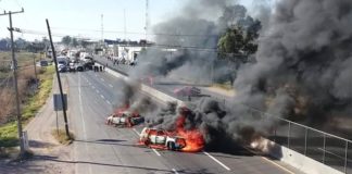 Vehicles burn in blockades on a Guanajuato highway.
