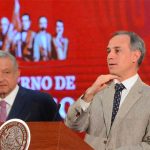 The president looks on as the deputy health minister addresses reporters at the daily press conference.