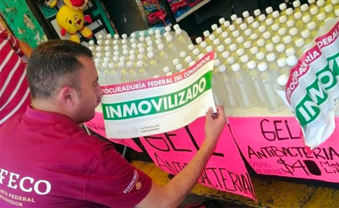 A Profeco agent seizes a product being sold as hand sanitizer.
