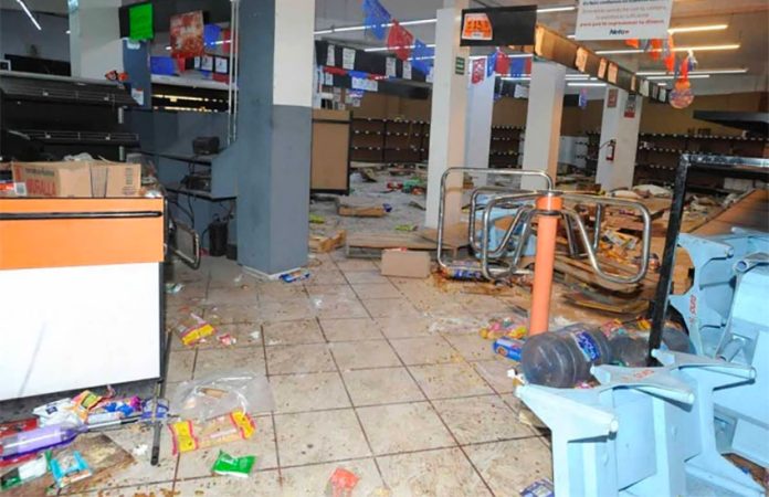 A store in México state that was damaged by looters Monday.