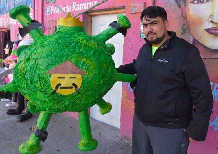 Ramírez and his coronavirus piñata.