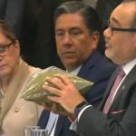 A senator uses baggies of oregano to demonstrate pot quantities.