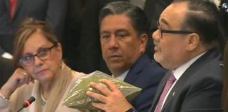 A senator uses baggies of oregano to demonstrate pot quantities.