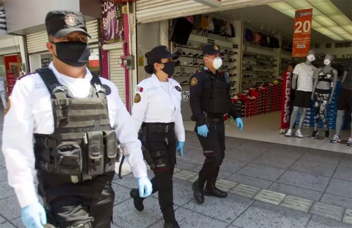 Masked security personnel on patrol in a shopping center.