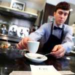 An Italian waiter practises 'social distancing.'
