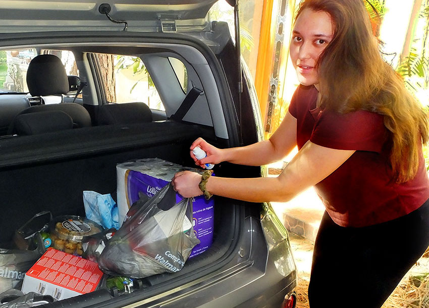 Xela Lloyd Ibarra is in charge of disinfecting each bag of groceries before carrying it into the house.