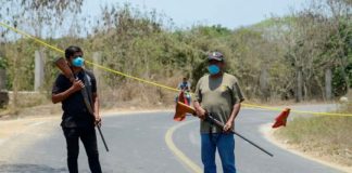 One of many checkpoints controlling access to communities across Mexico. The firearms would indicate they're serious.
