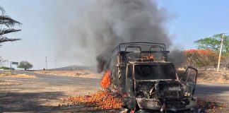 One of several vehicles set on fire to block highways on Sunday.