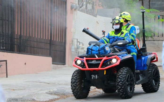 A quad is used to spray a disinfectant in public areas of Santa Catarina, Nuevo León.