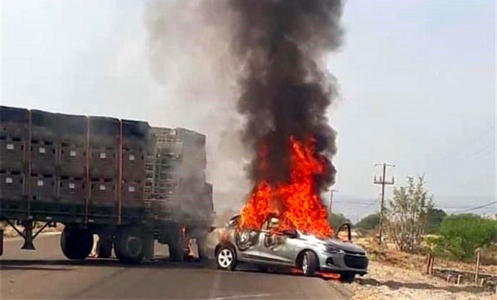 A vehicle burns Tuesday in a Guanajuato roadblock.