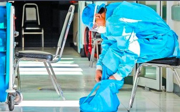 A healthcare worker in Toluca, México state, suits up with protective gear.