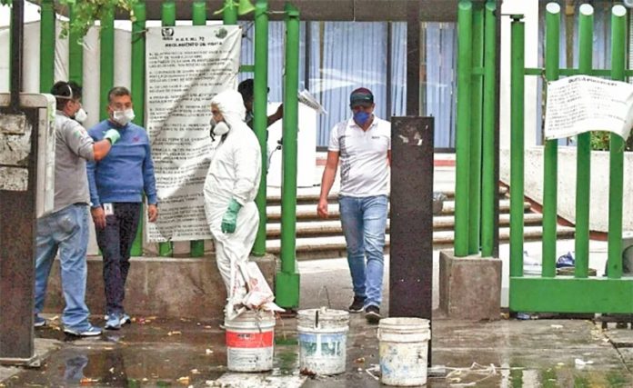 Workers disinfect the hospital in Tlalnepantla on Wednesday.