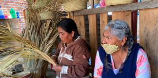 An artisan in Oaxaca wears one of the face masks made from palm leaves.