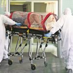 Medical personnel wheel a coronavirus patient into a Mexico City hospital.