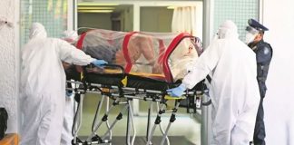 Medical personnel wheel a coronavirus patient into a Mexico City hospital.