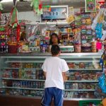 A child makes a purchase at a Mexican tiendita or corner store