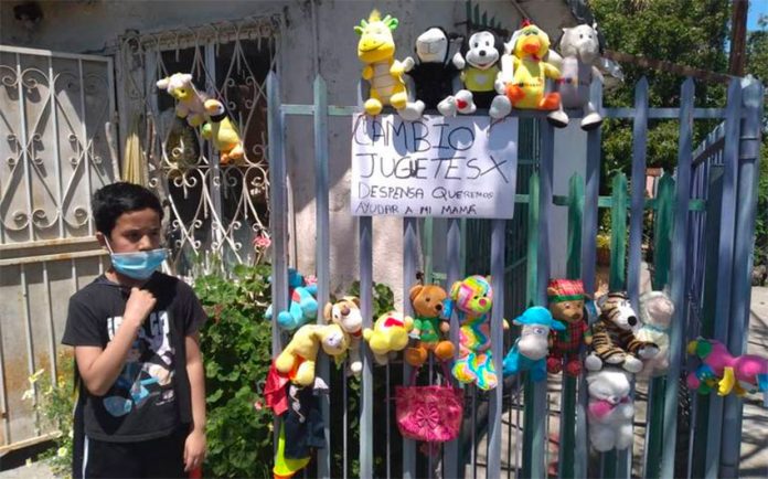 Alexis displays his toys for barter outside his Tijuana home.