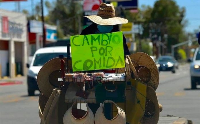 'Exchange for food,' reads street vendor Margarita's sign in Los Cabos.