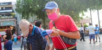 Amadeo Vidal sells masks on the street in Acapulco.