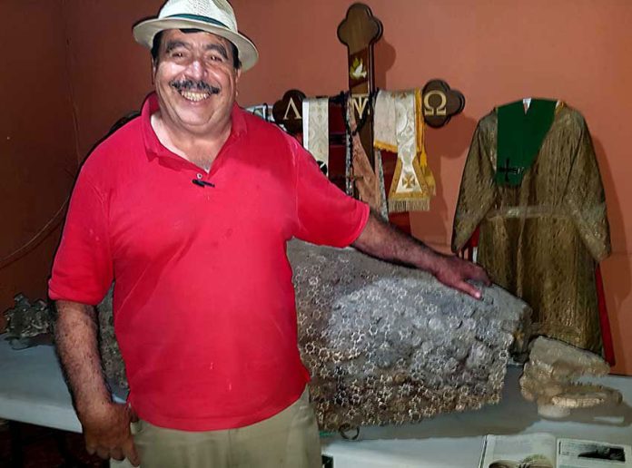 Gabriel Michel — and his winning smile — with glyptodont and vestments at his Jalisco museum.