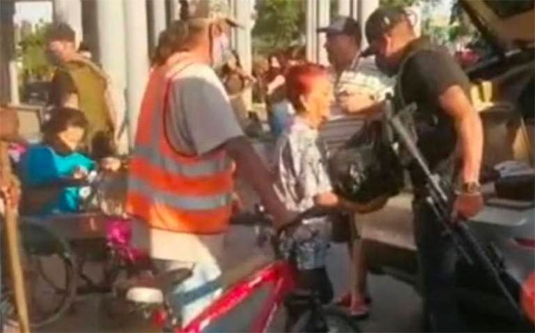 An armed man hands out provisions in Zapopan, Jalisco.