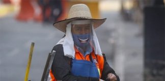 Dressed for the coronavirus, a cleaner wears a 'smile.'