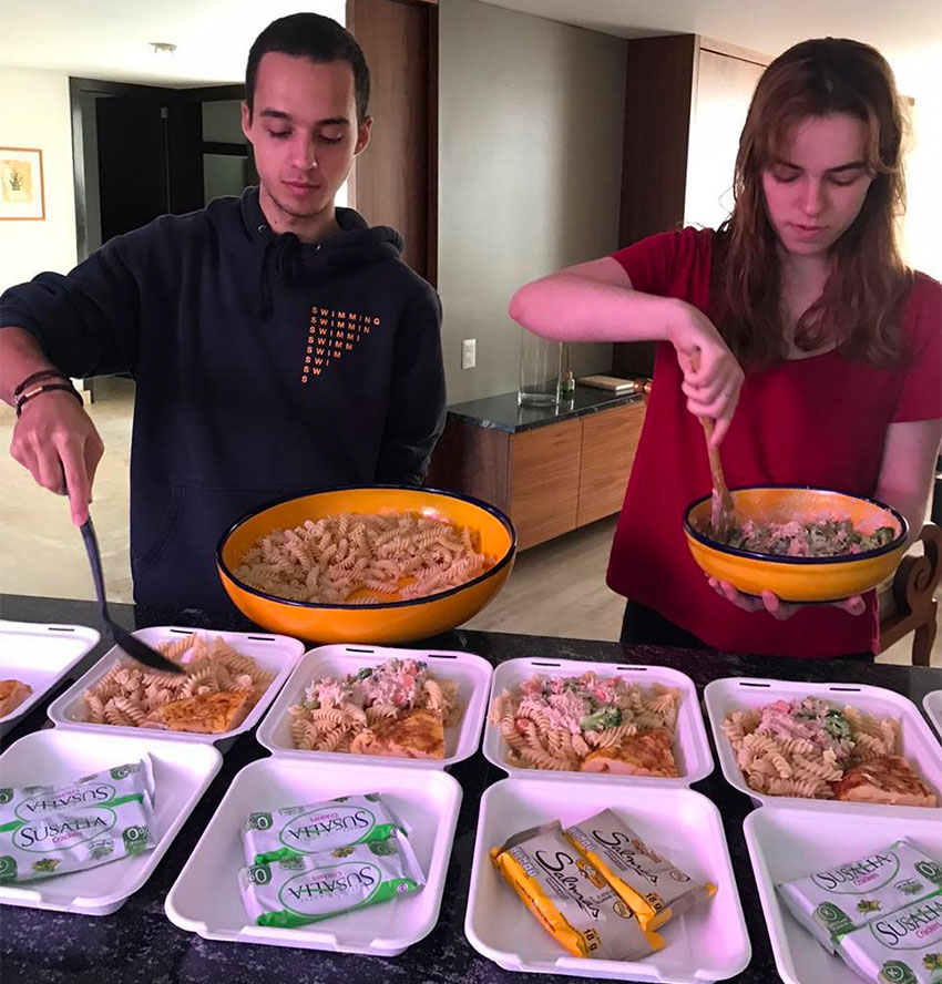 Volunteers prepare food to hand out to the needy.