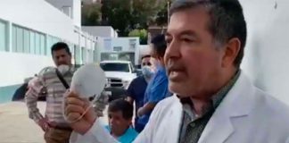 Dr. Rosales with the simple face mask he was given to attend to a patient in the coronavirus ward.