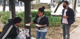 Staff from the Legion bar deliver food to people on the streets of Condesa.