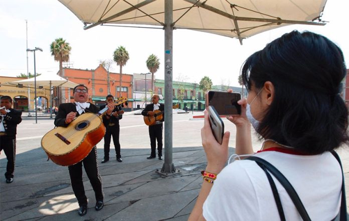 A woman live-streams mariachis in Mexico City for her mother, quarantined at home.