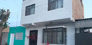 Memorial candles burn outside the Torreón home where three sisters were murdered early Friday.