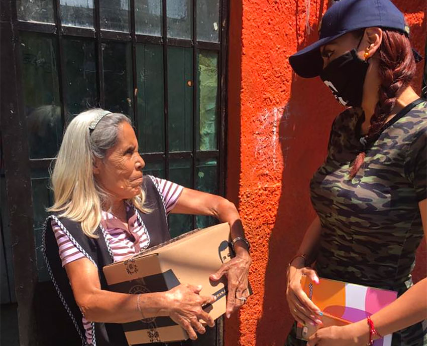 A representative of Alejandra Guzmán delivers a box of supplies.