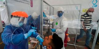 A healthworker administers a coronavirus test.