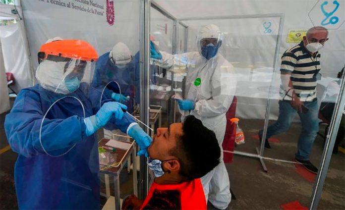 A healthworker administers a coronavirus test.