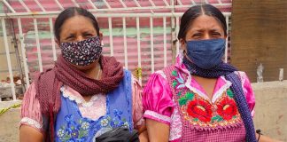 Women distribute face masks in Tlapazola, Oaxaca.