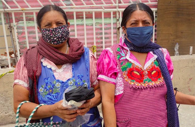Women distribute face masks in Tlapazola, Oaxaca.
