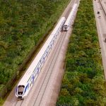 An artist's rendition of section four of the Maya Train, where it will run adjacent to the highway between Cancún and Izamal.