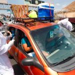 Health workers check the occupants of a vehicle heading out of Guadalajara on Friday.