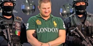 La Barbie smiles during his arrest in 2010.