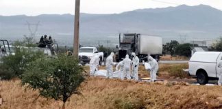 Forensic workers where bodies were found Friday morning.