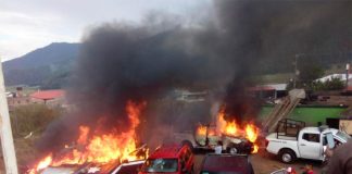 Vehicles burn in Cherán, Michoacán.