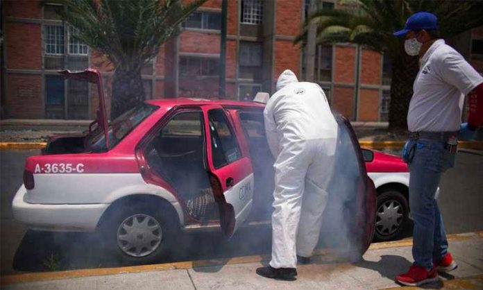 A taxi is disinfected against the coronavirus in Mexico City.