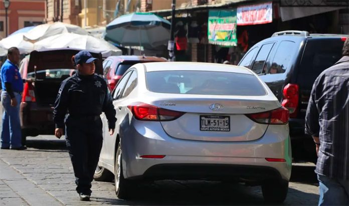 A traffic cop eyes a double-parked car in Oaxaca city.