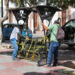 Workers remove a park bench from the Plaza de Armas in Lerdo, Durango.