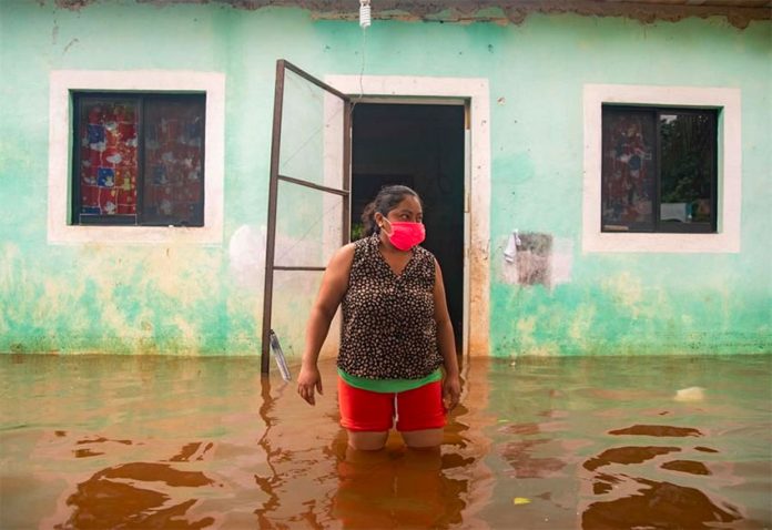 A woman surveys floodwaters in southeastern Mexico on the weekend.
